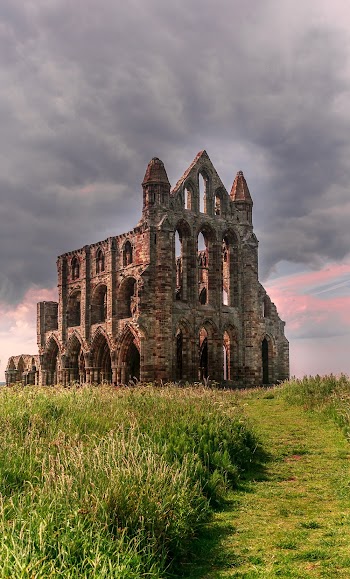 Photo of Old Church Building Under Cloudy Sky