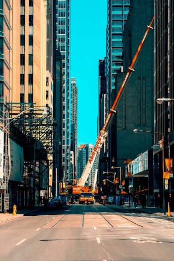 Photo of Orange and White Heavy Equipment on Road
