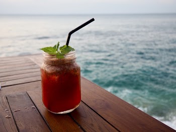 Photo of Orange Beverage in Clear Glass Mason Jar