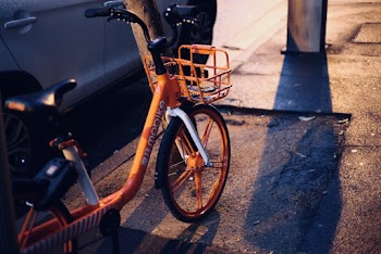 Photo of Orange Bicycle Parked on Pavement