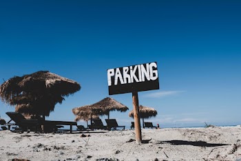 Photo of Parking Sign on Sand