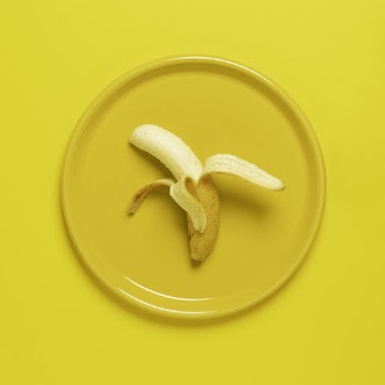 Photo of Peeled Banana on Yellow Plate and Background