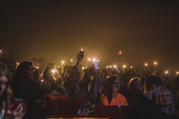 Photo of People Holding Smartphones With Flashlight