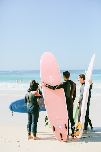 Photo of People Holding Their Surfboards