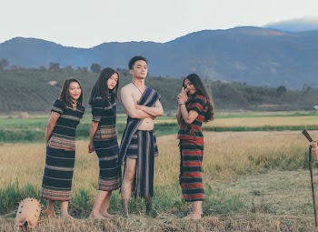 Photo of People Holding Traditional Clothes