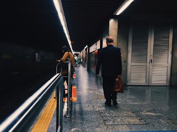 Photo Of People Leaning On Metal Railings