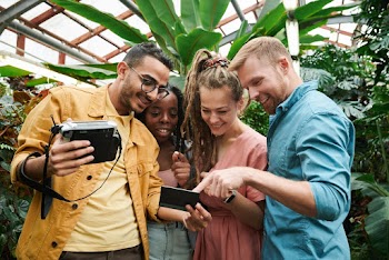 Photo Of People Looking At Photograph