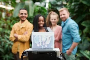 Photo Of People Looking At Photograph
