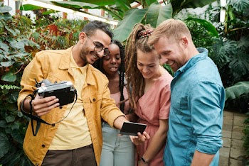 Photo Of People Looking At Photograph
