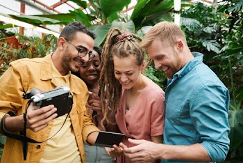 Photo Of People Looking At Photograph