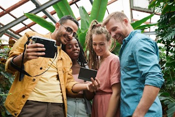 Photo Of People Looking At Photograph  