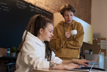 Photo Of People Looking On Laptop