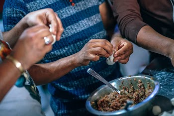 Photo of People Making Dumplings.