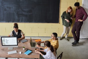 Photo Of People Near Blackboard