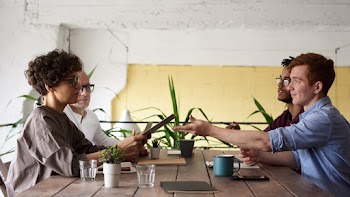 Photo Of People Near Wooden Table