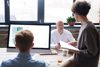 Photo Of People Near Wooden Table