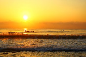 Photo of People on Boats During Golden Hour