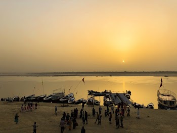 Photo of People on Shore During Golden Hour