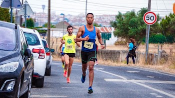 Photo of People Running Beside Parked Vehicles