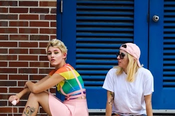 Photo of People Sitting in Front of Blue Door