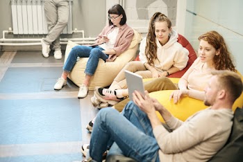 Photo Of People Sitting On Bean Bag Chairs