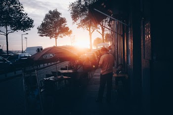Photo of People Sitting Outside the Restaurant