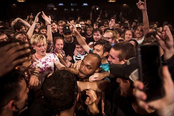 Photo of People Smiling and Raising Their Hands