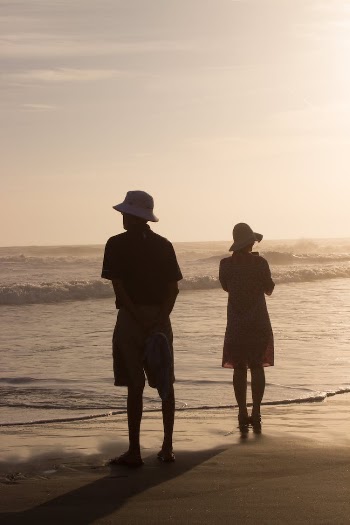 Photo Of People Standing Beside Beach
