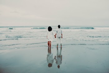 Photo Of People Standing Beside Sea