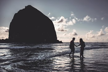Photo Of People Standing In The Shore