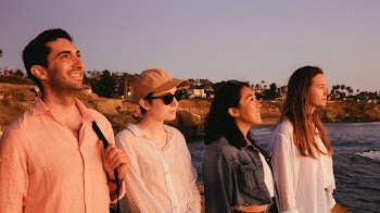 Photo Of People Standing Near Ocean
