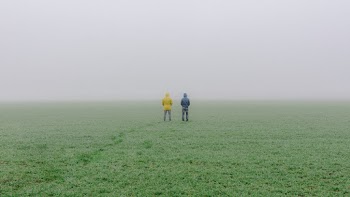 Photo of People Standing on Grass Field