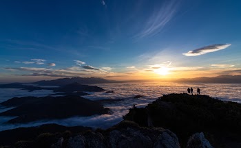 Photo of People Standing on Mountain