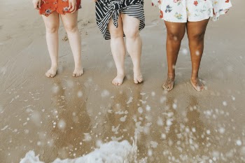 Photo of People Standing On Seashore
