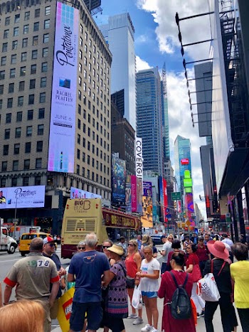 Photo of People Standing on Sidewalk