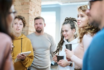 Photo of People Standing While Discussing