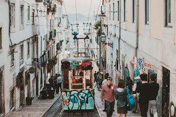 Photo of People Walking Beside Tram Train
