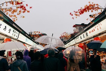 Photo of People Walking in Between Stores