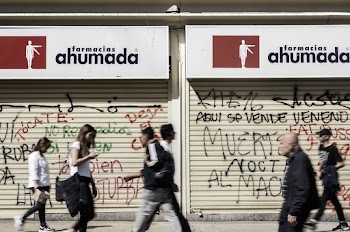 Photo of People Walking in Front of Pharmacy