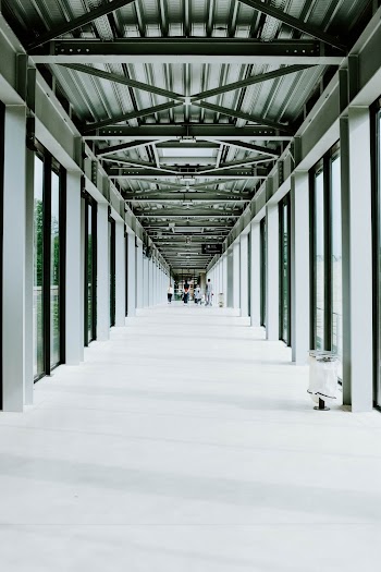 Photo of People Walking in Hallway