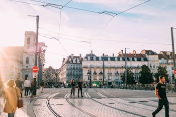 Photo of People Walking Near Tram Lines