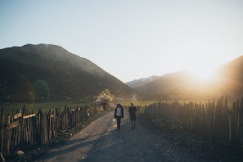 Photo of People Walking On Dirt Road