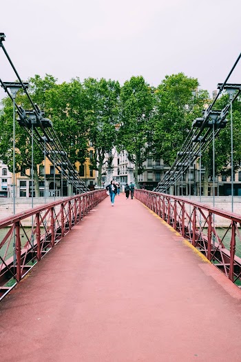 Photo of People Walking on Footbridge