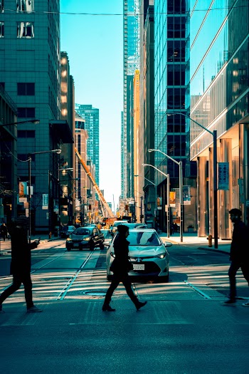 Photo of People Walking on Pedestrian Crossing