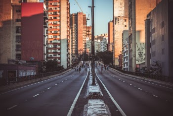 Photo of People Walking on Road Near Buildings