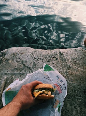 Photo of Person's Hand Holding Hamburger