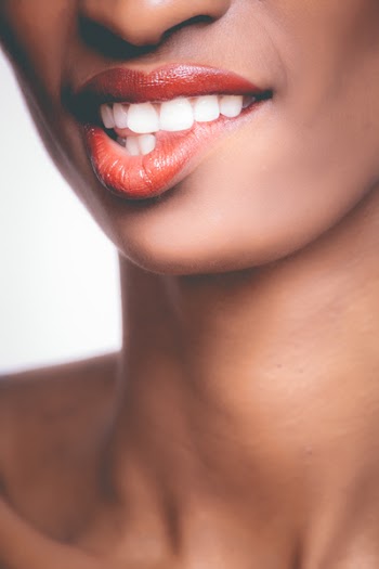 Photo of Person Biting It's Own Red Lips