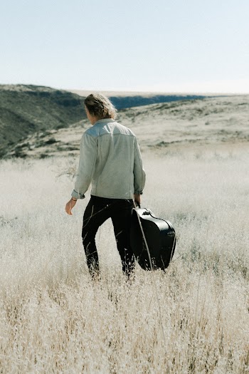 Photo Of Person Bringing Guitar