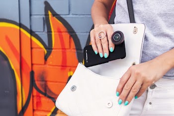 Photo of Person Carrying Bag While Holding Smartphone