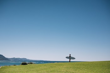 Photo of Person Carrying Surfboard